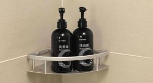 three black bottles on a shelf on a wall at City Comfort Inn Wuhan Guanggu Textile University in Wuhan