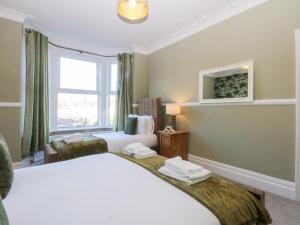 a hotel room with a bed and a window at Canning Lodge in Colwyn Bay