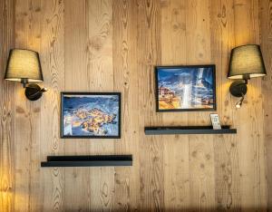 three pictures on a wall with three lights on it at Val Thorens Cosy Pieds des pistes Centre Val Thorens 2 chbres in Val Thorens