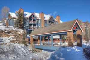 a large house with a porch in the snow at River Mountain Lodge by Breckenridge Hospitality in Breckenridge
