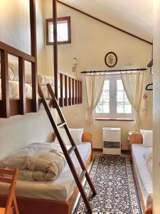 Ένα ή περισσότερα κρεβάτια σε δωμάτιο στο たんばら高原 ペンション スターガーデン