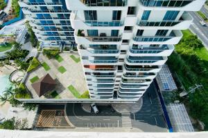 an aerial view of a tall apartment building at Bali Videl - Studio with Queen Bed & Beach View in San Fernando +2 photos