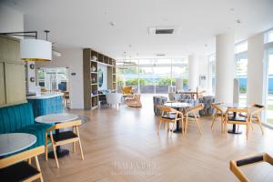 a dining room with tables and chairs and a cafeteria at Bali Videl - Studio with Queen Bed & Beach View in San Fernando