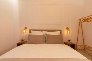 a bedroom with a white bed with two night stands at Kazimierz Residence Apartments by Staymoovers in Kraków