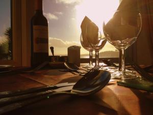 a table with a bottle of wine and two glasses at Membly Hall Hotel in Falmouth