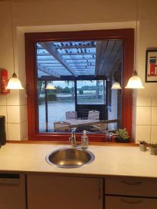 fregadero en una cocina con ventana grande en Lovely Holiday Home With Views Of Fields, en Lebøl