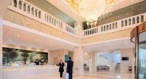 a couple of people standing in a lobby at Vienna Hotel Tibet Lazi Mount Everest in Ch'ü-hsia