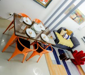 a living room with a table and a couch at Clark Stays Yellow in Iba +34 photos