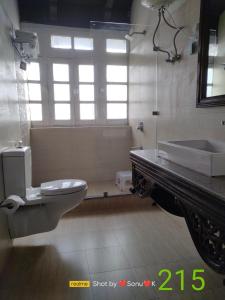 ein Badezimmer mit Toilette, Badewanne und Waschbecken in der Unterkunft Belvedere Palace Nainital in Nainital + 15 Fotos