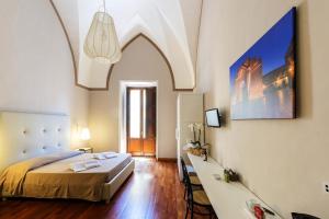 a bedroom with a bed and a desk in a room at B&B Centro Storico Lecce in Lecce