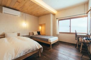 Un pat sau paturi într-o cameră la ANSHINDO