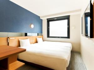 Postel nebo postele na pokoji v ubytování Hotel Meldia Kyotoshijoomiya