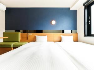 Postel nebo postele na pokoji v ubytování Hotel Meldia Kyotoshijoomiya