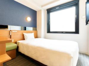a hotel room with a bed and a window at Rakuten STAY URBAN Kyoto Shijo Omiya in Kyoto