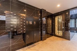 a bathroom with black marble walls and a door at Mi-Hotel Kitashinjuku 北新宿 in Tokyo +61 photos