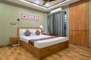 a bedroom with a large bed in a room at FabHotel MB International in Kolkata