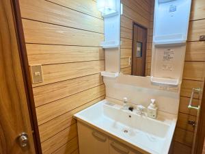 a bathroom with a sink and a mirror at 海の宿mare in Hakui +88 photos