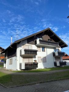 a white building with balconies on the side of it at Ferienwohnung Falkensteinblick in Pfronten