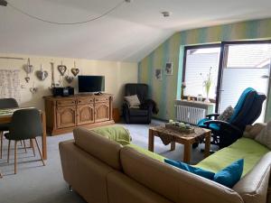 a living room with a couch and a table at Ferienwohnung Falkensteinblick in Pfronten
