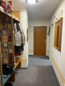 a hallway with a door and a room with a jacket at Ferienwohnung Falkensteinblick in Pfronten