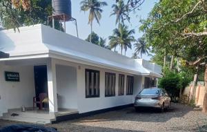 a small house with a car parked in front of it at Anaaya Riverside Nest in Jāmb