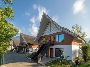 a house with a staircase in front of it at Hotel Niagara Parapat in Parapat