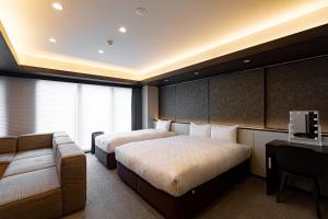 Postel nebo postele na pokoji v ubytování GOLD STAY Nagoya Osu