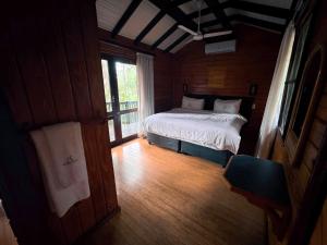 a bedroom with a bed in a room with a window at Imvubu Lodge in Richards Bay