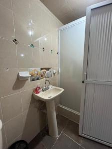 a bathroom with a sink and a shower at Posada Oasis in Cuetzalán del Progreso