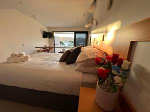 a bedroom with a large bed with red roses on it at BlueWater Penthouse GuestSuite 3 in Newport +5 photos