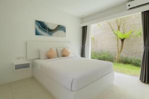 Ένα ή περισσότερα κρεβάτια σε δωμάτιο στο The Kamalaya Hotel Garden & Wedding House