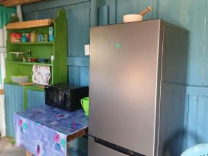 Riverview Cottage : ثلاجة في المطبخ مع طاولة ورف