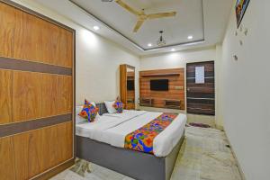 a bedroom with a large bed and a television at Via Classic Square I in Pune +15 photos