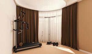 a room with a treadmill in front of a window at GreenTree Inn Jiangsu Xuzhou Western 3rd Ring Road Xiyuan Express Hotel in Xuzhou