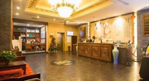 a lobby with a bar in a store with a christmas tree at James Joyce Coffetel Xian Dayanta Metro Station Branch in Xi'an