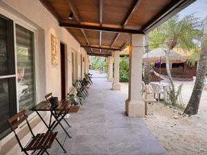 a patio with chairs and tables and an umbrella at 峇里島漫活民宿Bali Slow Homestay in Dongshan +39 photos