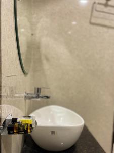 a bathroom with a white sink on a counter at Kumar Green Resort in Guwahati +27 photos