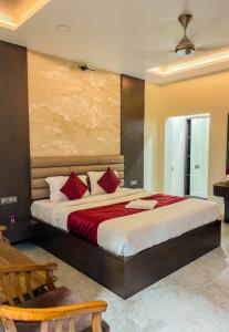 a bedroom with a large bed with red pillows at Kumar Green Resort in Guwahati