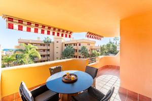 a balcony with a table and chairs and a building at Azul Cala Mijas Apartment in La Cala de Mijas