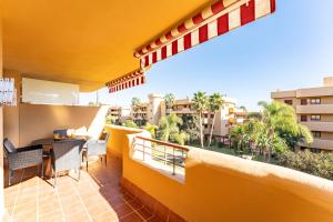 a balcony of a hotel with a table and chairs at Azul Cala Mijas Apartment in La Cala de Mijas