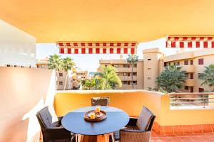 a patio with a table and chairs on a balcony at Azul Cala Mijas Apartment in La Cala de Mijas