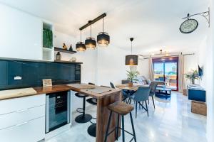 a kitchen and dining room with a table and chairs at Azul Cala Mijas Apartment in La Cala de Mijas +23 photos
