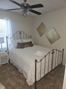 a bedroom with a bed with a ceiling fan at Atlanta 3 Bedroom Home - by PriMary EVolution Properties in Atlanta +23 photos