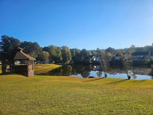 a gazebo in a field next to a lake at Atlanta 3 Bedroom Home - by PriMary EVolution Properties in Atlanta