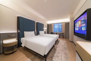 Una cama o camas en una habitación de Manxin Hotel, Guilin Road, Changchun Zoo and Botanical Garden