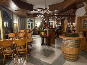 a room with a table and chairs and a bar at Hotel Normandie in Schildow