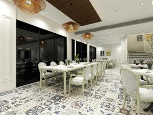 a dining room with a long table and chairs at Studio by Jardin in Indore +15 photos