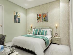 a bedroom with a bed and two pictures on the wall at Studio by Jardin in Indore