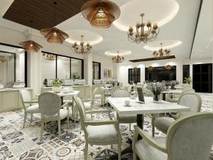 a dining room with tables and chairs and chandeliers at Studio by Jardin in Indore