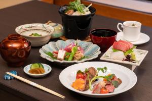 a table with plates of food and cups and chopsticks at soraichi in Sendai